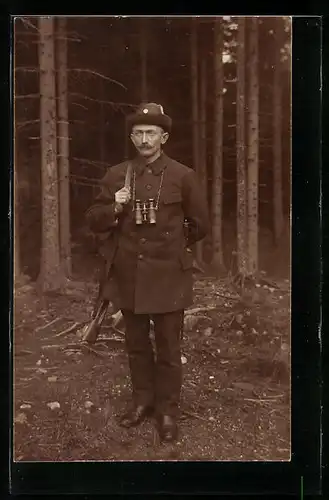 Foto-AK Jäger mit umgehängtem Gewehr und Fernglas im Wald