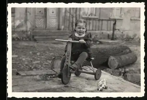 Fotografie Mädchen fährt mit Dreirad 1955