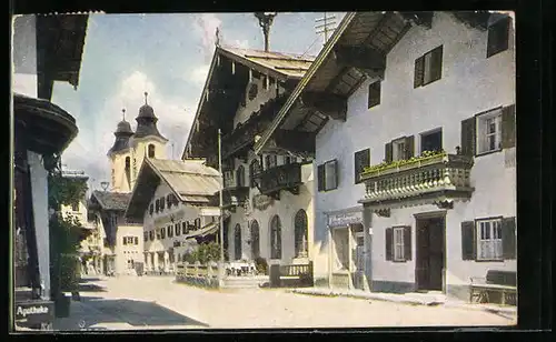 AK St. Johann, Strassenpartie mit Geschäft, Apotheke und Kirche