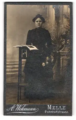 Fotografie A. Wehmann, Melle, Bahnhofstrasse, Junge Frau im Kleid mit Zeitung