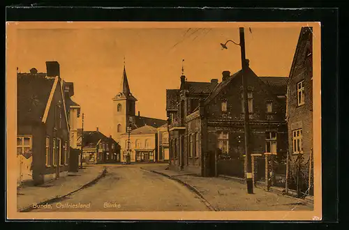 AK Bunde /Ostfriesland, Strasse Blinke mit Kirche