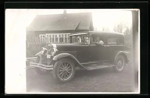 Foto-AK Mann im Auto auf einer Wiese