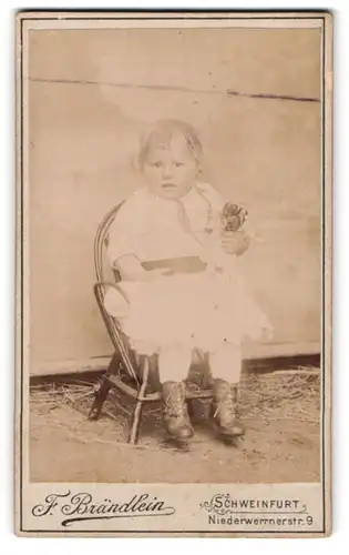 Fotografie F. Brändlein, Schweinfurt, Niederwerrnerstr. 9, Kind im weissen Kleid mit Puppe