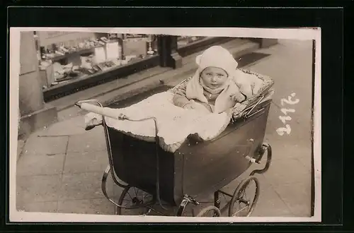 Foto-AK Kleinkind im Kinderwagen vor einem Schaufenster