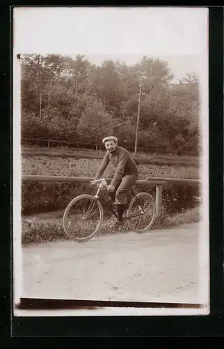 Foto-AK Mann sitzt auf seinem Fahrrad