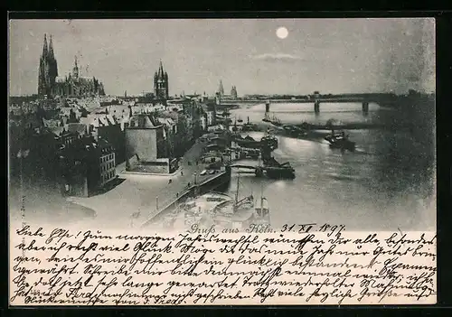 AK Köln a. Rhein, Stadtansicht vom Rheinufer mit Brücke und Dom bei Mondschein