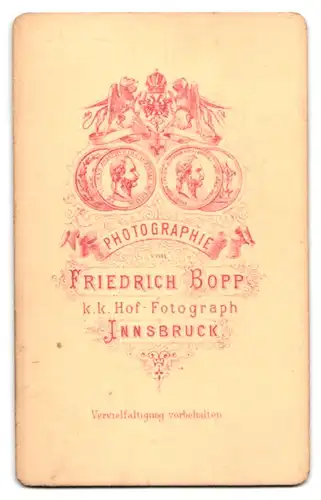 Fotografie Fr. Bopp, Innsbruck, Soldat mit wolligem Backenbart und zurückgekämmten Haaren