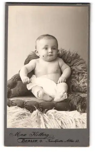 Fotografie Max Kolberg, Berlin-O., Frankfurter Allee 53, Halbnacktes Kleinkind sitzt auf einem Sessel