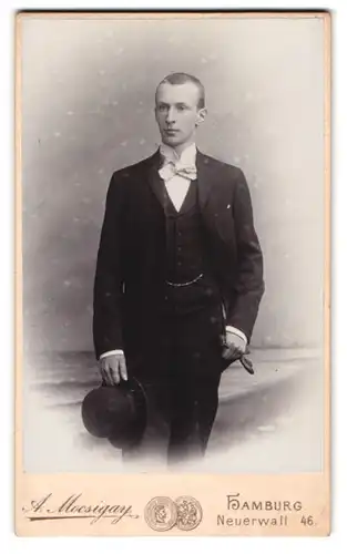 Fotografie Atelier A. Mocsigay, Hamburg, Neuerwall 46, elegant gekleideter junger Mann mit Melone in der Hand