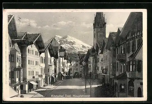 AK Kitzbühel, Hauptstrasse mit Kirche im Sonnenschein