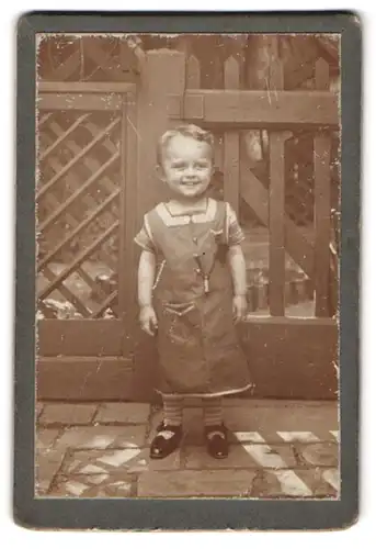 Fotografie unbekannter Fotograf und Ort, kleines fröhliches Mädchen im Kleid