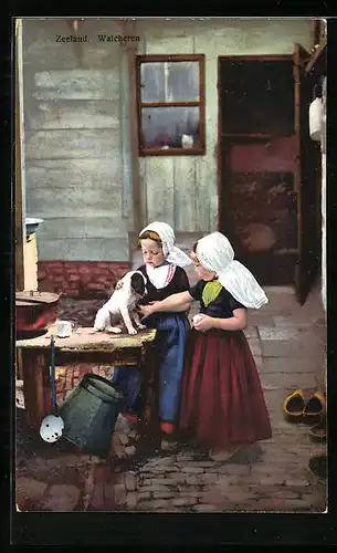 AK Kleine Mädchen in niederländischer Tracht mit einem Hundewelpen