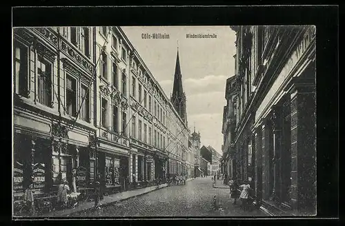 AK Köln-Mülheim, Windmühlenstrasse mit Geschäften und Kirchturm