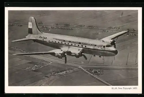 AK Flugzeug Douglas DC-4 der K.L.M. Royal Dutch Airlines am Himmel