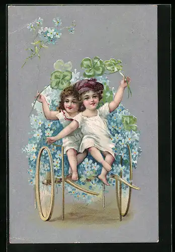 Präge-AK Zwei Kinder mit Glücksklee sitzen auf einem Wagen mit Blumen