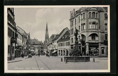 AK Offenburg, Strasse mit Geschäften, Kirche und Brunnen