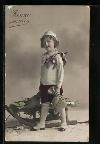 AK Kind mit Geldsack und Klee auf einem Schlitten