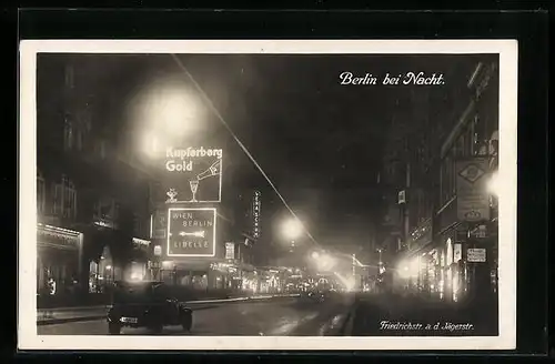 AK Berlin, bei Nacht, Friedrichstrasse an der Jägerstrasse