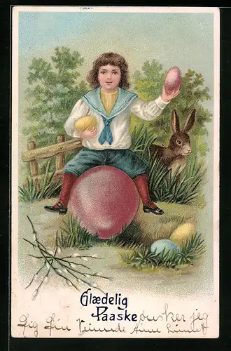 Künstler-AK Osterhase und Junge mit Ostereiern im Garten