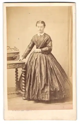 Fotografie H. Mencke, Itzehoe, hübsche junge Frau im seidenen Kleid mit Armbanduhr