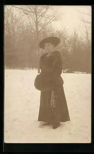 Foto-AK Frau mit Muff und Schlittschuhen im Schnee
