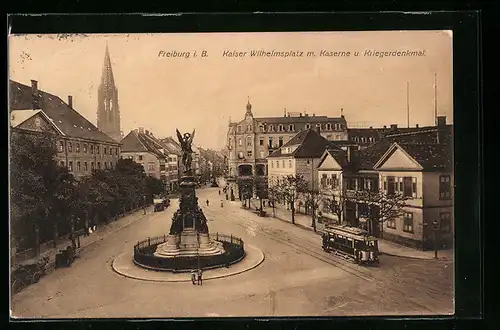 AK Freiburg i.B., Strassenbahn am Kaiser Wilhelmsplatz m. Kaserne u. Kriegerdenkmal