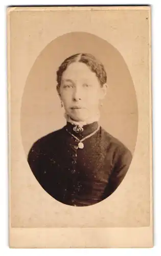 Fotografie Symonds & Co., Portsmouth, englische Dame im dunklen Kleid mit Brosche und Ohrringen