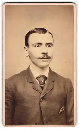 Fotografie unbekannter Fotograf und Ort, junger Mann im Anzug mit Krawatte und Moustache