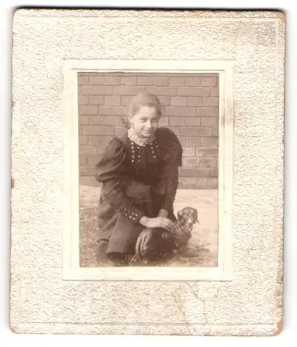 Fotografie unbekannter Fotograf und Ort, junge Frau streichelt eine Bronze Dackel Figur