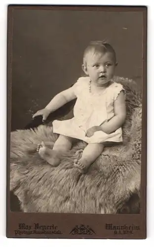 Fotografie Max Beyerle, Mannheim, Niedliches Kind mit grossen Augen im weissen Kleidchen sitzt auf Stuhl