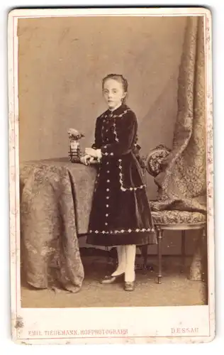 Fotografie Emil Tiedemann, Dessau, Akensche-Str. 4, Junges Mädel im Samtkleid am Tisch stehend