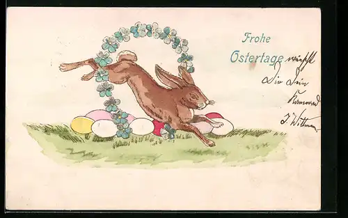 AK Osterhase springt durch einen blauen Blütenkranz, Gruss zum Osterfest