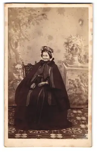 Fotografie unbekannter Fotograf und Ort, Portrait ältere Dame im schwarzen Winterkleid mit Mantel und Lederhandschuhen