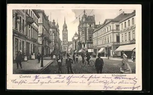 Präge-AK Krefeld, Passanten und Radfahrer auf der Rheinstrasse