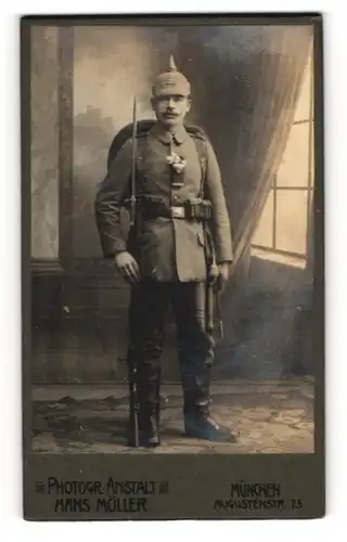 Fotografie Hans Möller, München, Soldat in Uniform mit Pickelhaube Tarnbezug, Ausmarschgepäck, Kriegsausmarsch