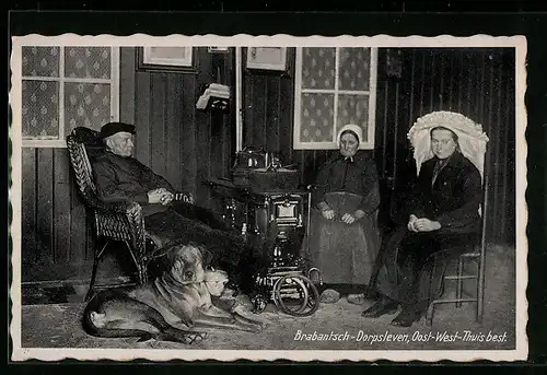 AK Szene am Ofen mit Hund, niederländische Trachten