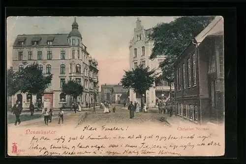 AK Neumünster, Christian-Strasse mit Geschäft und Litfasssäule
