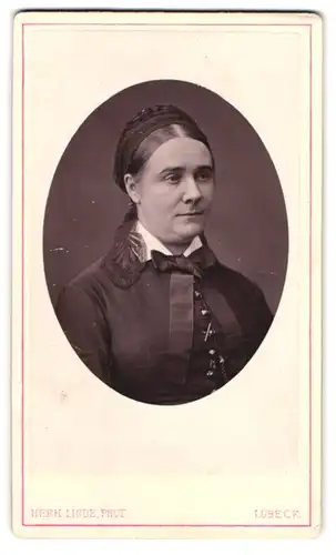 Fotografie Herm. Linde, Lübeck, Johannisstr. 31, Portrait junger Frau mit Haarband und Flechtzopf