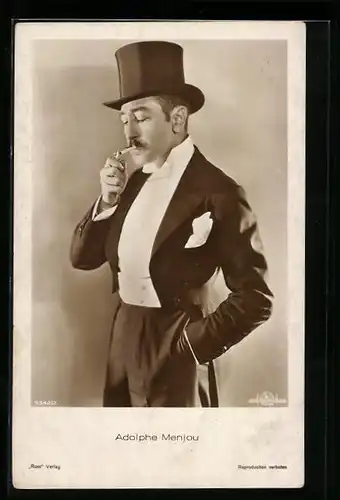 AK Schauspieler Adolphe Menjou raucht eine Zigarette