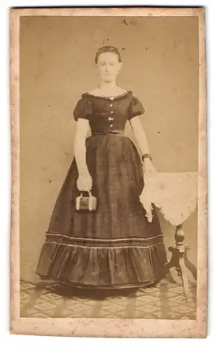 Fotografie unbekannter Fotograf und Ort, Junge Frau im weiten Kleid mit Handtasche