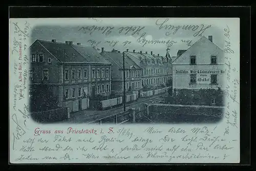 Mondschein-AK Priestewitz i. S., Strassenpartie mit Destillation und Kolonialwarenhandlung Reif aus der Vogelschau