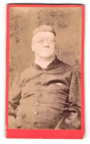 Fotografie unbekannter Fotograf und Ort, älterer Priester mit Kappe und Brille, 1881