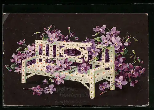 AK Mit Gänseblumen und Veilchen geschmückte Bank, Blumenbild