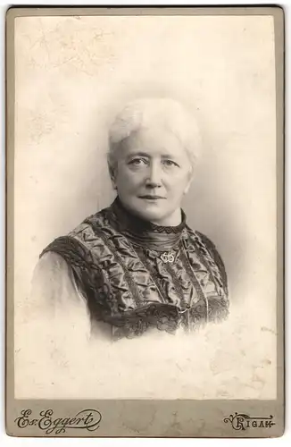 Fotografie E. v. Eggert, Riga, Ältere Dame im Kleid mit Kragenbrosche