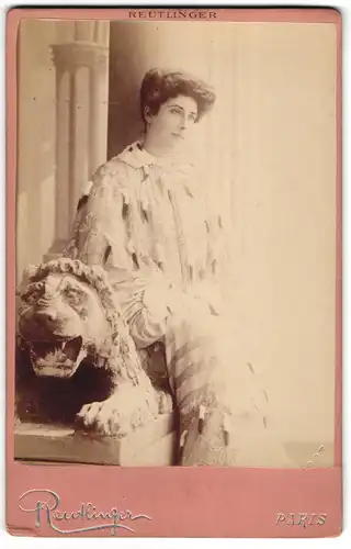 Fotografie Reutlinger, Paris, Schauspielerin  Beauregard  sitztend an einer Löwenstatue, Belle Époque