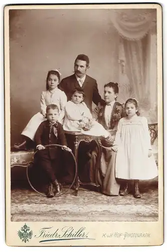 Fotografie Friedr. Schiller, Wien, Eltern mit ihren vier Kindern posieren im Atelier