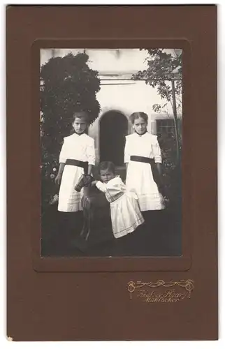 Fotografie Atelier Fleury, Mühlacker, zwei junge Mädchen mit Geschwisterchen samt Holzpferd im Garten