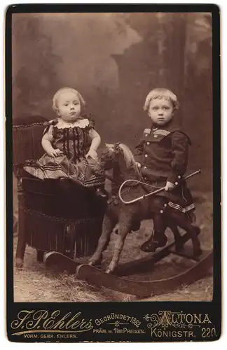 Fotografie F. P. Ehlers, Altona, zwei Kleinkinder mit ihrem Schaukelpferd im Atelier