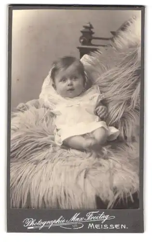 Fotografie Max Freitag, Meissen, Rothe Stufen 3, Zufrieden blickendes Baby auf einem Fell