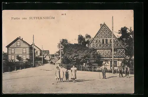 AK Sufflenheim, Ortspartie mit gemusterter Hausfassade, Passanten und Strasse